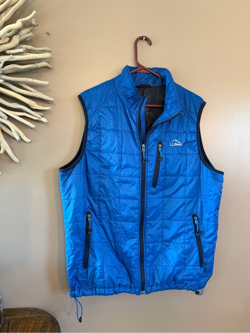 L.L.Bean blue PrimaLoft packaway vest features a full-zip front and quilted grid